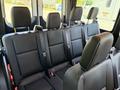 Interior seating area of a 2023 Mercedes-Benz Sprinter with multiple black leather seats featuring seat belts