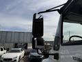 A side mirror of a 2011 International 4300 truck showing its reflective surface and mounting bracket
