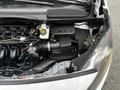 The engine compartment of a 2014 Ford Transit Connect showing the engine components and air intake system