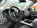 Interior view of a 2018 RAM 1500 showcasing the steering wheel dashboard and center console with controls and a touchscreen display