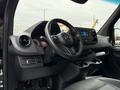 Interior dashboard of a 2022 Mercedes-Benz Sprinter featuring the steering wheel and advanced control panel with touchscreen display and audio controls