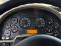 Close-up of the dashboard of a 2011 International WorkStar displaying various gauges including RPM speedometer fuel oil and temperature indicators