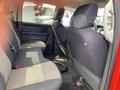 Interior view of the back seat of a 2012 RAM 2500 featuring two gray cloth seats with a patterned design and a visible seatbelt on the side