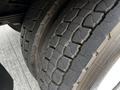 Close-up of a worn tire from a 2006 Hino 268 showing visible cracks and tread wear on the rubber surface