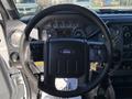 Steering wheel and dashboard of a 2016 Ford F-550 with gauges controls and buttons visible