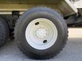 A close-up of a wheel on a 2009 International 7500 featuring a white rim and a large black tire with visible tread pattern and branding