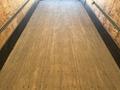 A 2015 Freightliner M2 106 truck with a wooden floor inside the cargo area featuring visible nail holes and a smooth surface