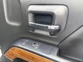 The interior door handle and window controls of a 2017 Chevrolet Silverado 1500