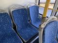 Interior view of blue patterned seats inside a 2016 Grande West Vicinity bus with yellow handrails