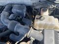 Close-up of the engine compartment of a 2013 Ford Expedition showing various components including hoses and a coolant reservoir