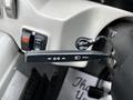 A control lever inside a 2015 Spartan School Bus used for turn signals and headlights with marked symbols for direction and illumination