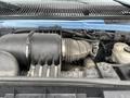 Close-up view of the engine compartment of a 2009 Ford Econoline showing the air intake system and various engine components