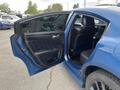 A 2022 Dodge Charger with an open front door revealing black leather seats and interior detailing