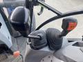 Close-up of the control levers and gearshift of a 2016 New Holland T475 tractor