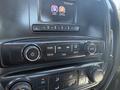 Close-up of the infotainment and climate control system in a 2016 GMC Sierra 1500 featuring buttons for radio media tone and menu settings