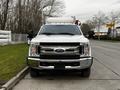 A white 2019 Ford F-350 Super Duty truck is prominently displayed from the front with a chrome grille and two side mirrors