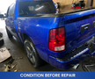 A blue 2019 RAM 1500 Classic pickup truck with a glossy finish and an extended cab parked in a garage showing wear and signs of use