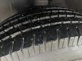 Close-up of a tire from a 2021 Mercedes-Benz Sprinter showing tread depth and surface details with some dirt particles visible