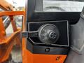 Close-up of the control panel of a 2001 Agco ST40 featuring a black rotary switch for turning lights on and off