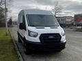 A white 2020 Ford Transit van with a black grille parked on the street