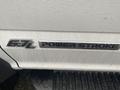 A close-up of the badge on a white 2021 Ford F-550 displaying the text 67L POWER STROKE TURBO DIESEL