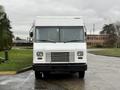 A white 2018 Ford E-450 box truck with a flat front and large windshield is parked facing forward