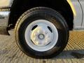 A close-up view of a white wheel and tire from a 2017 Ford Econoline showing the tire tread and rim design