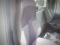 A driver's seat in a 2016 International WorkStar 7500 with gray fabric and a textured pattern designed for comfort and support