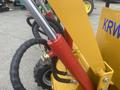 Close-up of the hydraulic system on a 2024 AGT KRW 23 Mini loader showing red cylinder and black hoses connected to the equipment