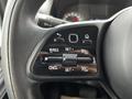 Close-up of a steering wheel control panel for cruise control in a 2021 Mercedes-Benz Sprinter with buttons for set resume cancel and additional settings