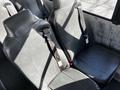 Interior seating of a 2022 Blue Bird Vision with two black leather seats featuring seat belts