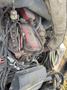 Close-up of a 2015 Global Street Sweeper's engine components including wires and hoses connected to a red engine block