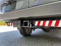 A 2017 Mercedes-Benz Sprinter with a visible tow hitch featuring red and white reflective stripes