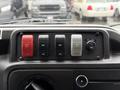 Dashboard controls of a 2017 Ford E450 featuring buttons for entry door heat and angle light as well as a knob for HVAC settings