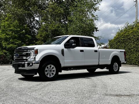 2020 Ford F-350 Super Duty in white with a crew cab and four-wheel drive visible side profile and chrome accents