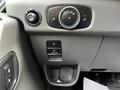 Dashboard controls of a 2022 Ford Transit with various knobs and buttons for climate and light settings
