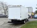 A white 2019 Ford Econoline box truck with a closed cargo compartment and a black bumper parked at an angle