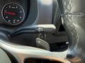 A close-up view of the gear shifter and start engine button in a 2023 Mercedes-Benz Sprinter vehicle interior
