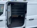 2017 Ford Transit Connect with an open side door revealing shelving units inside the cargo area