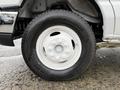 Close-up of a white tire and wheel of a 2019 Ford Econoline with a Hankook tire on a silver rim