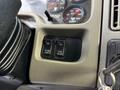 Dashboard controls featuring three switches labeled for plow light and fan activation in a 2011 International WorkStar