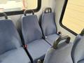 The interior seating of a 2017 Chevrolet Express featuring four blue upholstered seats with armrests and seatbelts