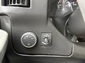 Interior controls of a 2015 GMC Savana including a light control knob and a button for the dome light