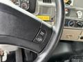Close-up of the steering wheel of a 2006 Sterling L7500 featuring a control button for cruise control settings