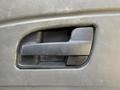 Black door handle of a 2009 International 7500 truck showing a textured grip and sleek design