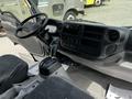 Interior view of a 2018 Hino 195 showing the dashboard steering wheel gear lever and seats with a focus on the control panel