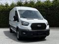 A 2022 Ford Transit van is shown in the foreground with a sleek white exterior and a large black grille