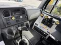 Interior view of a 2016 Freightliner 108SD with a gear shift lever and various control panels for operations and features
