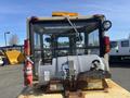 A 1993 Hyster H80XL forklift viewed from the rear featuring a large propane tank secured on the back along with a fire extinguisher and various control levers visible inside the cabin
