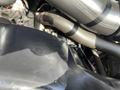 Close-up of the engine compartment showing parts of a 2014 Ford F-350 SD including hoses and metallic components